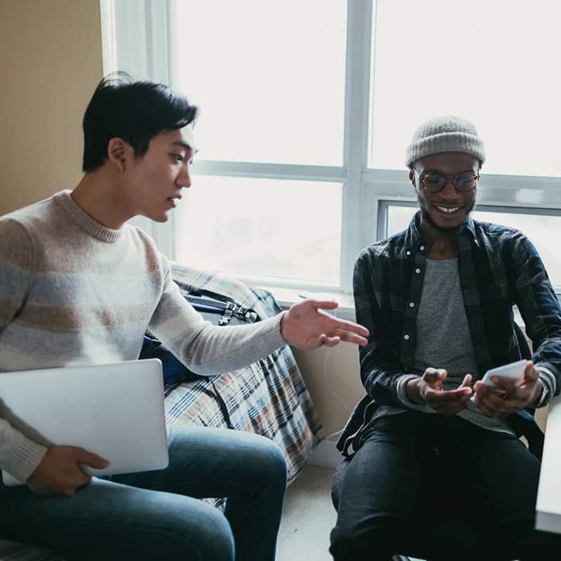 Two friends talking in an apartment